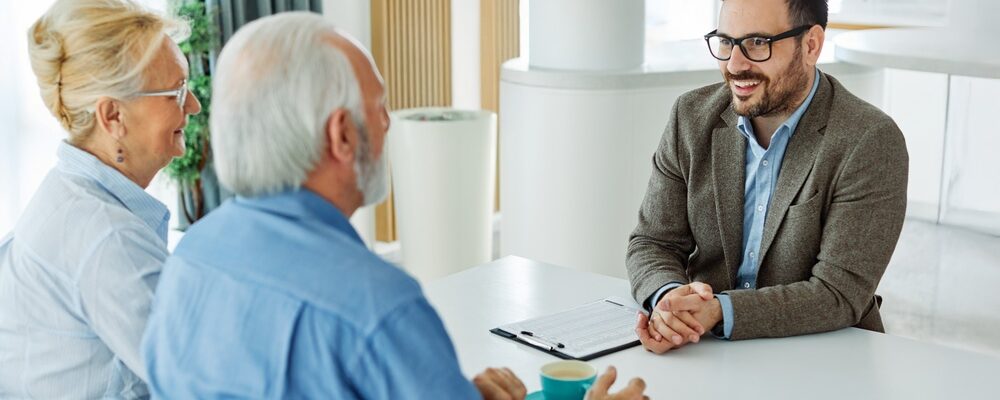 Senior,Couple,Having,A,Meeting,With,An,Agent,,Businessman,,Salesperson