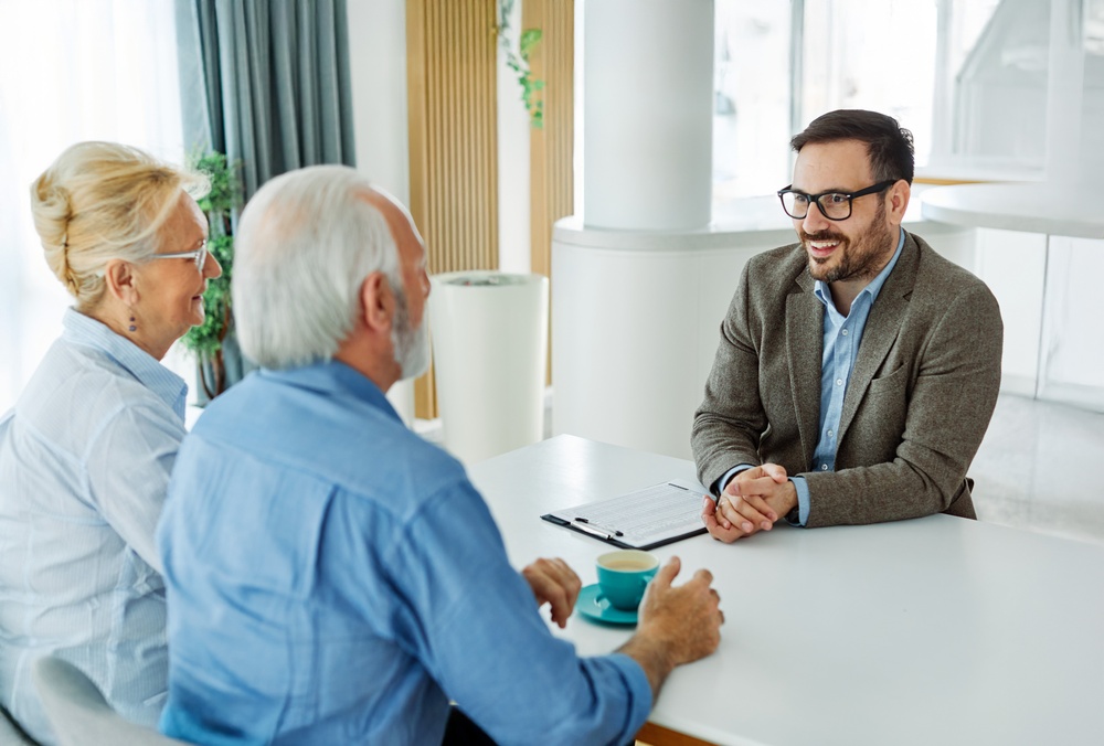 Senior,Couple,Having,A,Meeting,With,An,Agent,,Businessman,,Salesperson